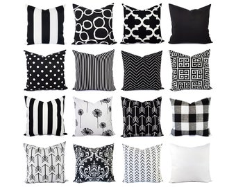 May include: A set of 16 black and white throw pillows with various geometric and abstract patterns. The pillows are arranged in a grid pattern on a white background.