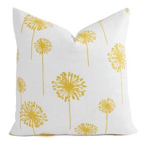 May include: White pillow with a yellow dandelion pattern.