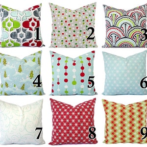 May include: Nine different pillow covers with various holiday-themed patterns. The patterns include geometric designs, snowflakes, polka dots, and Christmas trees. The pillow covers are all in various shades of red, green, blue, and white.