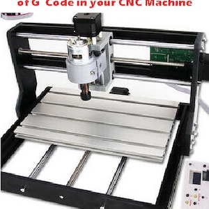 May include: A black CNC machine with a silver work surface and a black motor with a silver spindle. The machine has a control panel with buttons and a display screen.