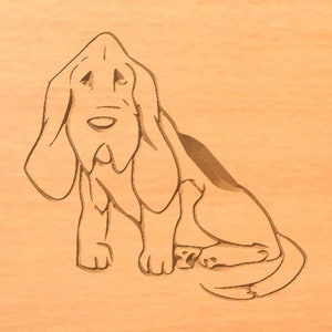 May include: Line art illustration of a Bloodhound dog sitting with its head tilted up. The dog is drawn in a simple, stylised manner, with its long ears and droopy jowls clearly visible.
