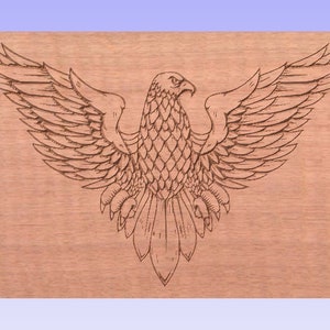 May include: A detailed line drawing of an eagle with its wings spread wide, etched into a light brown wooden surface.