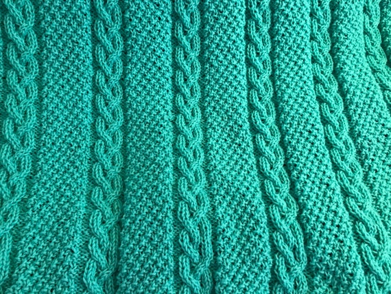 Knitted cable throw in Sea Green.