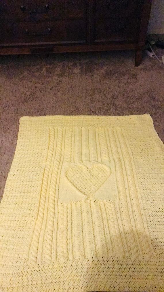 Knitted yellow cable heart baby blanket
