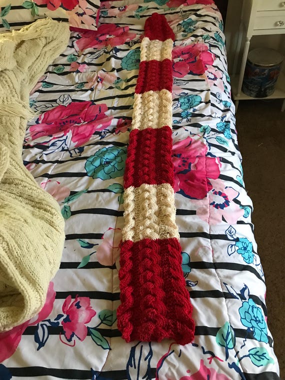 Red and white knitted cable scarf