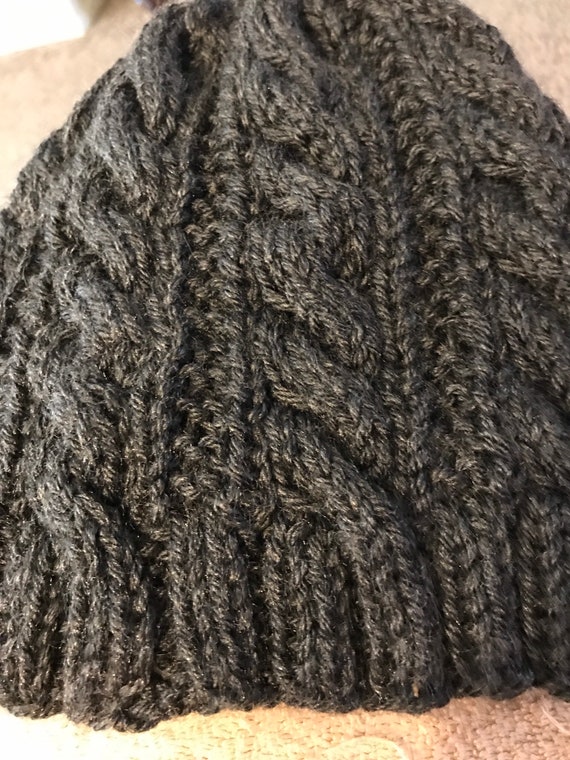 Knitted cable hat in soft yarn.