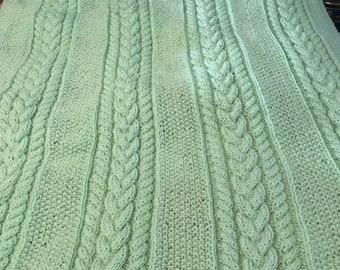 Knitted cable baby blanket in mint green