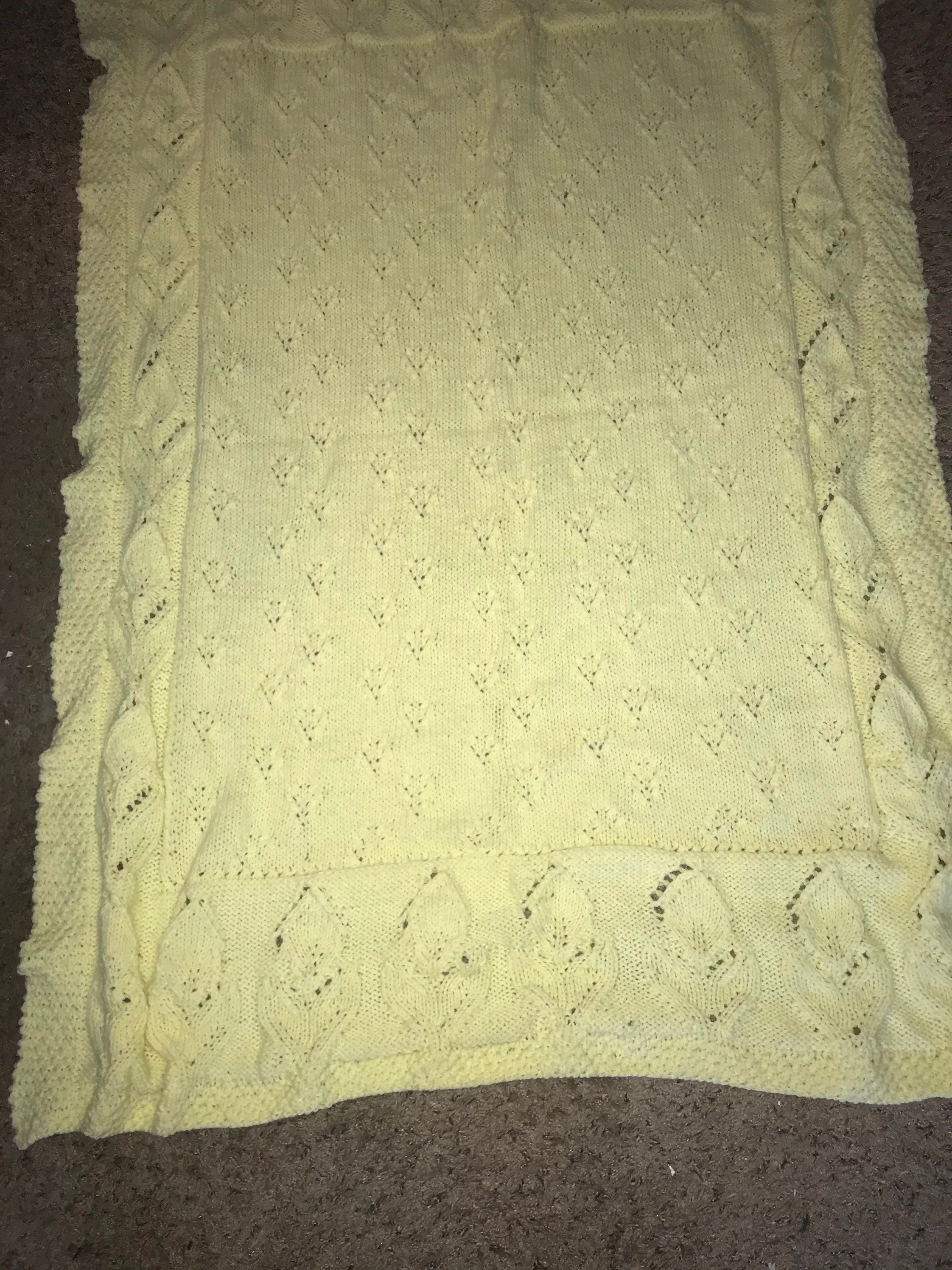 Bright yellow baby boy or girl blanket in soft fingering baby yarn.