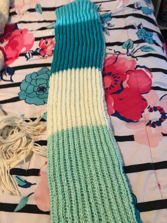 Knitted blue and white scarf in a soft and comfy stitch.