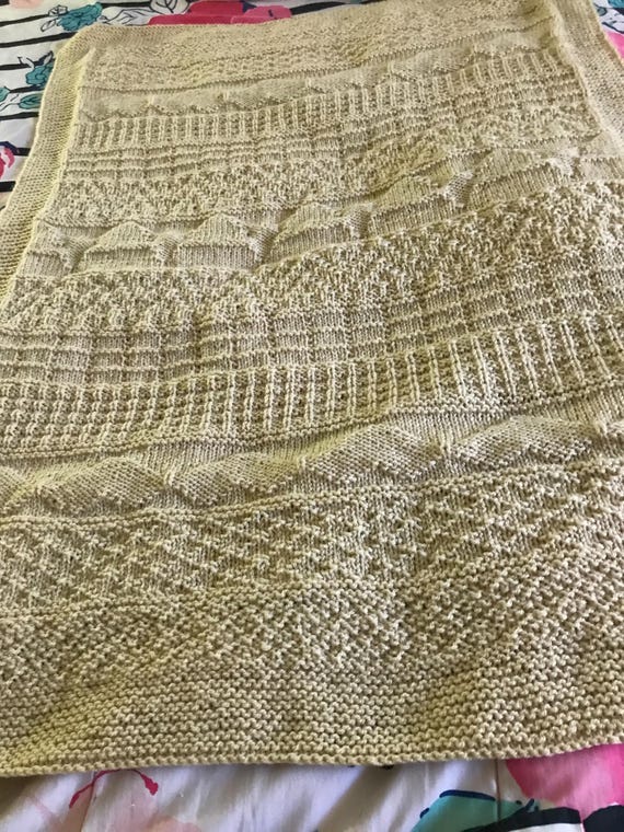 Knitted cream colored hearts and stars baby blanket.