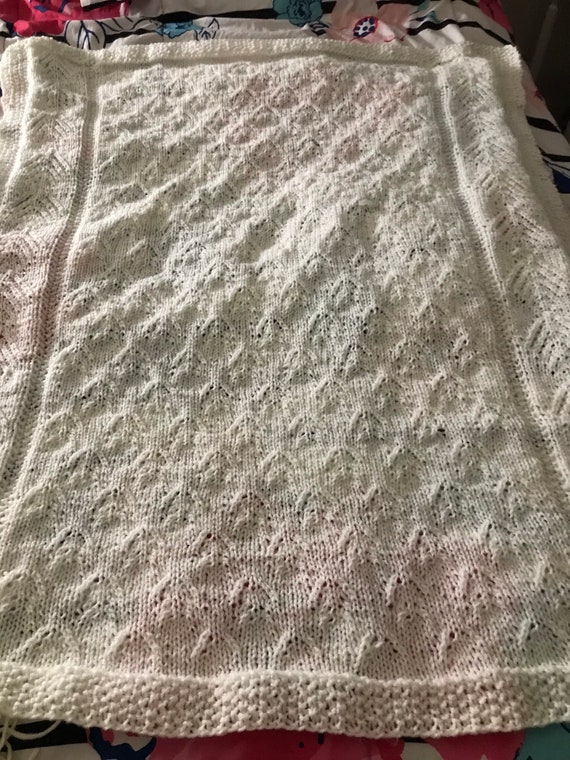 Knitted white lace baby blanket