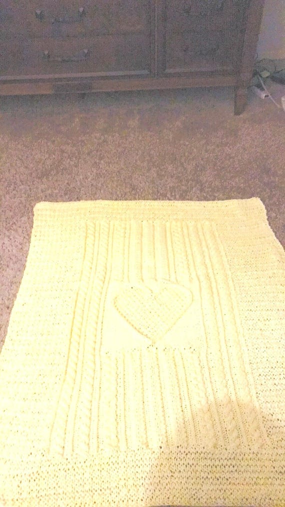 Knitted yellow cable heart baby blanket