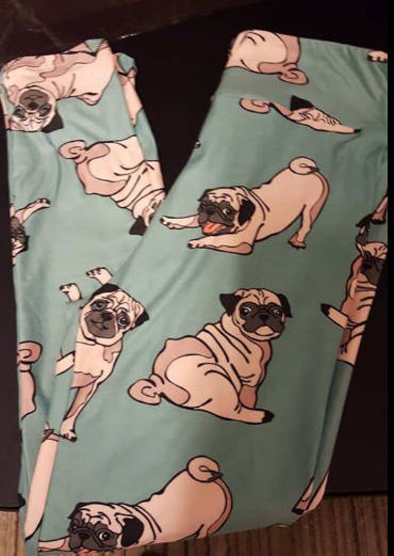 May include: Teal leggings with a repeating pattern of pugs in various poses. The pugs are light brown with black noses and eyes.
