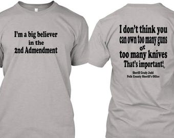 May include: A gray t-shirt with a quote about the 2nd Amendment on the front and a quote from Sheriff Grady Judd on the back. The quote on the back says, "I don't think you can own too many guns or too many knives. That's important!"