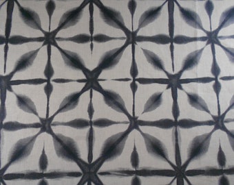 May include: A black and white fabric with a repeating geometric pattern. The pattern is made up of a series of overlapping circles and lines, creating a starburst effect.