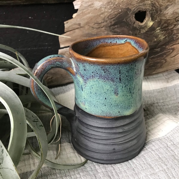 Turquoise coffee mug with carved texture