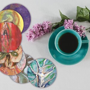 May include: A set of eight round coasters with colorful, abstract designs featuring nature-inspired themes. The coasters are arranged in a circle on a white surface.