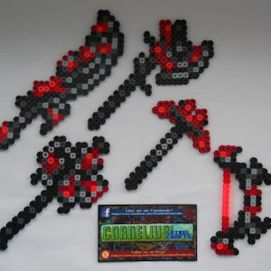 May include: A collection of pixel art weapons, including a sword, axe, and bow, crafted from black, gray, and red beads. The designs are reminiscent of video game aesthetics. A business card with the text "Cornelius Pixel Crafts" is also present.