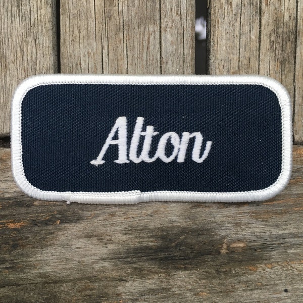 Alton. A dark blue work shirt patch that says "Alton" in white script with white border