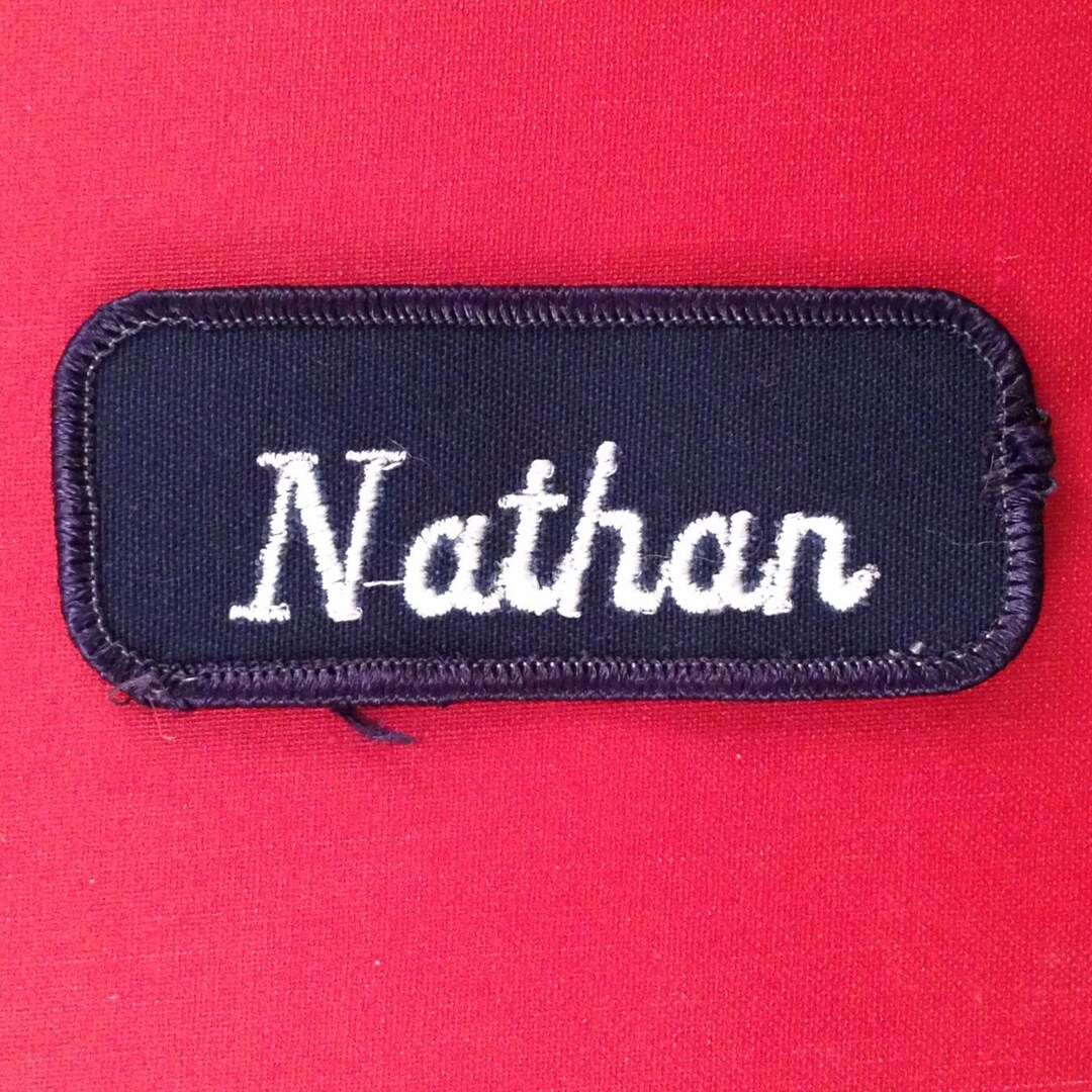 Nathan. A Navy Blue Work Shirt Patch That Says nathan in White Script