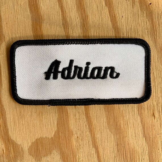 Adrian. A white work shirt patch that says "Adrian