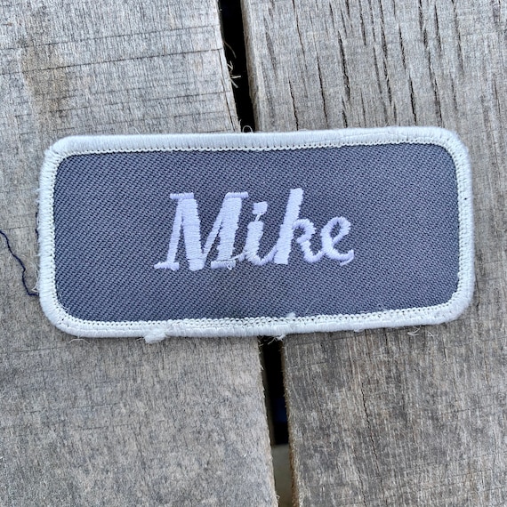 Mike. A gray patch with "Mike" in white script