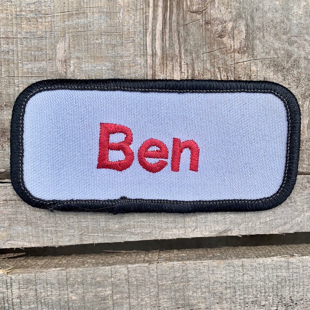 Ben. A Light Gray Work Shirt Name Patch That Says ben in Red Print With