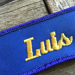 Luis. A royal blue work shirt patch that says Luis in yellow script image 2