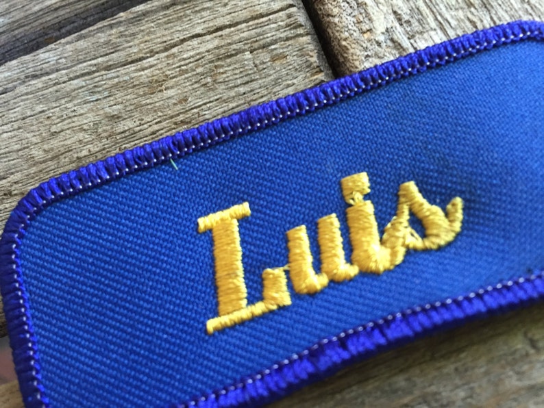 Luis. A royal blue work shirt patch that says Luis in yellow script image 2