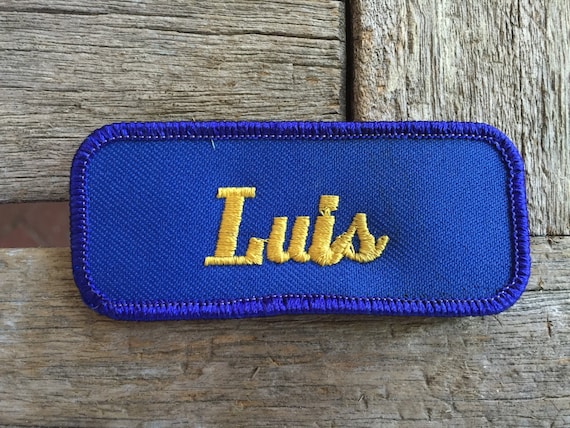 Luis. A royal blue work shirt patch that says "Lui