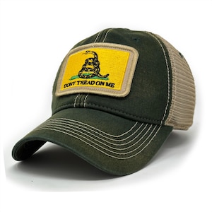 May include: A green and tan trucker hat with a yellow patch featuring a coiled snake and the text "Don't Tread On Me".
