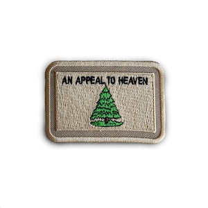 May include: A beige embroidered patch with the text "An Appeal to Heaven" and a green pine tree in the center.