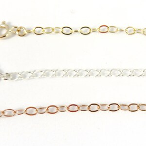 May include: Three gold, silver, and rose gold chain extenders with lobster clasps. The extenders are different lengths and styles.