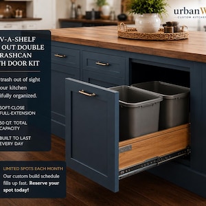 May include: A dark blue kitchen island featuring a Rev-A-Shelf roll-out double trash can with a door kit. The unit includes two gray plastic bins, a wooden drawer base, and metal glides. Text on the image reads Rev-A-Shelf Roll Out Double Trashcan.