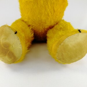 A close up of the foot pads of the old Petz teddy bear. The right one shows some dark spots.