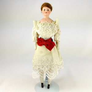 Antique Kestner  Bisque Doll made around 1927 with brown glass eyes 11 inches tall
