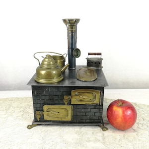 Antique doll stove 1900s by Leo Prager with dishes 7 by 6 inches