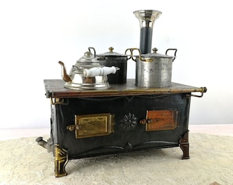 Antique Marklin doll stove 1900 to 1910 produced with original dishes 10 by 7 inches