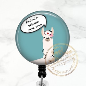 May include: A teal blue round badge reel with a white llama wearing a pink and white nurse's hat and a stethoscope. The llama is holding a speech bubble that says "Alpaca wound for you!"