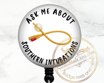 May include: A white round badge holder with a black retractable clip. The badge features a yellow medical tube with a red tip and the text "Ask Me About Southern Intubations".