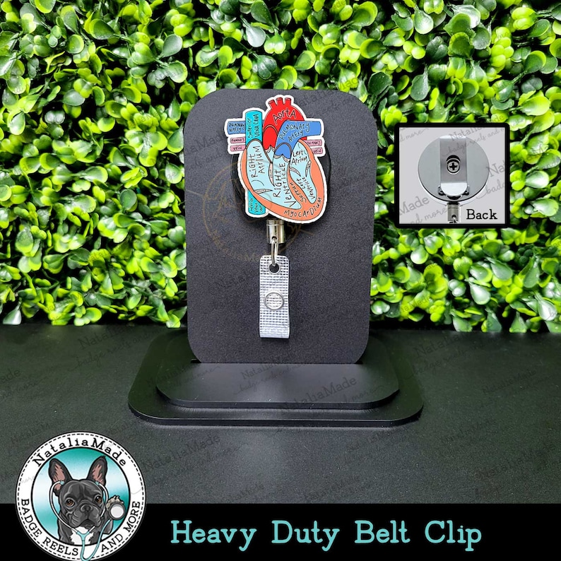 May include: A heavy-duty belt clip with a retractable badge reel. The badge reel features a colorful diagram of a human heart with labels. The clip is black, and the reel has a silver-colored, textured strap. The text "Heavy Duty Belt Clip" is at the bottom.