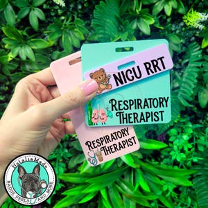 May include: Three rectangular acrylic badge reels in pastel pink, mint green, and lavender. The lavender piece features a cartoon bear and the text NICU RRT. The mint piece shows lungs and the text RESPIRATORY THERAPIST. The pink piece displays a stethoscope and coffee cup with the text RESPIRATORY THERAPIST.