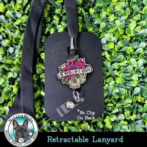 May include: Black retractable lanyard with a skull and floral design charm. The charm has the text "Be Afraid & Do It Anyway". The lanyard has a black and white bulldog logo with the text "Natalia Made Badge Reels and More".