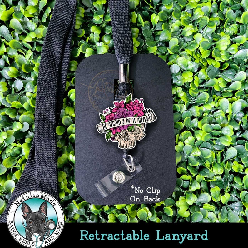 May include: Black retractable lanyard with a skull and floral design charm. The charm has the text "Be Afraid & Do It Anyway". The lanyard has a black and white bulldog logo with the text "Natalia Made Badge Reels and More".