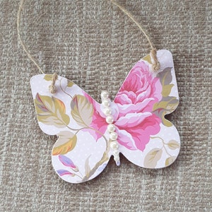 Shabby chic hanging wooden Butterfly decoupaged with high quality paper and embellished with a pearl body