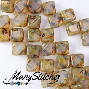 May include: A collection of small, square, translucent glass beads with a brown and green marbled pattern. The beads have a slightly iridescent finish.