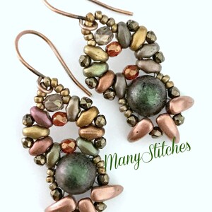 May include: A pair of earrings featuring a copper wire design and an assortment of brown, gold, and green beads. The earrings are embellished with a large, dark green bead at the centre.