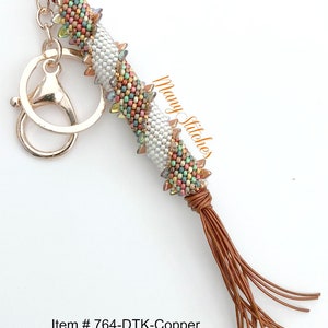 May include: A colorful beaded keychain with a copper-colored tassel and a gold-colored key ring. The beads are arranged in a spiral pattern and the tassel is made of multiple strands of leather. The keychain is labeled "Item # 764-DTK-Copper".