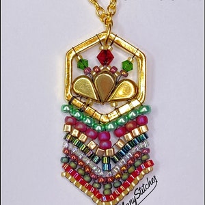 May include: Gold necklace with a hexagonal pendant featuring a red and green crystal design and a beaded fringe. The pendant is adorned with gold beads and a gold leaf design. The necklace is labelled "Christmas".