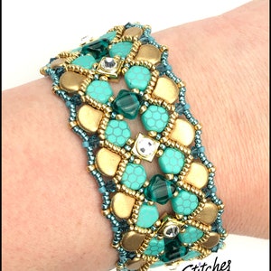 May include: A turquoise and gold beaded bracelet with a geometric design. The bracelet is made with small, round beads and features clear and green crystals.